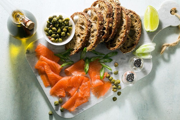 Rye bread with smoked salmon on a marble board winter snack