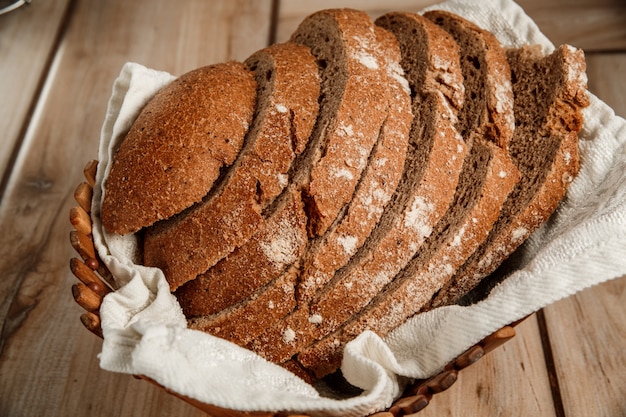 Rye bread on wooden plate on wooden table