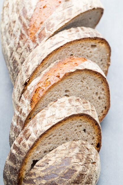 Rye fresh bread on he gray background.