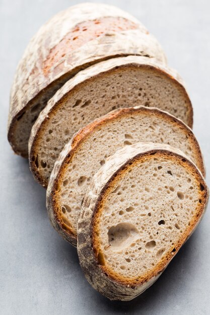 Rye fresh bread on he gray surface.