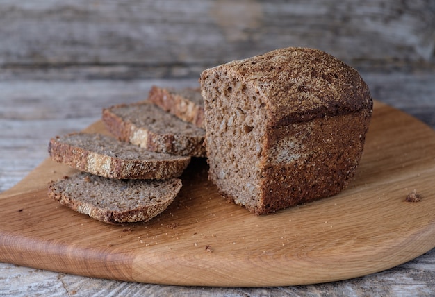 Rye and wheat homemade bread with sunflower seeds on oak Board