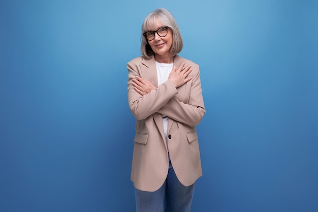 S middleaged woman in a stylish laconic jacket on a studio background with copy space