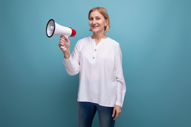 S woman with blond hairstyle with loudspeaker announces interesting news