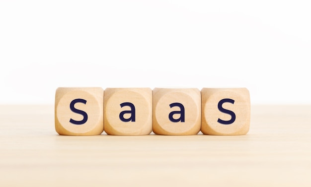 Saas word on wooden blocks on table. Copy space