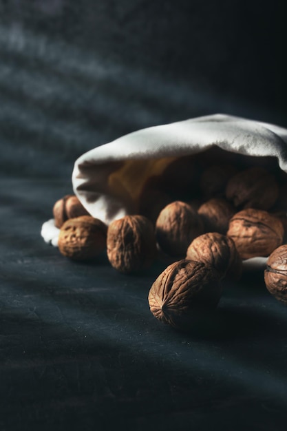 Sack of walnuts with copy space in dark mood shot