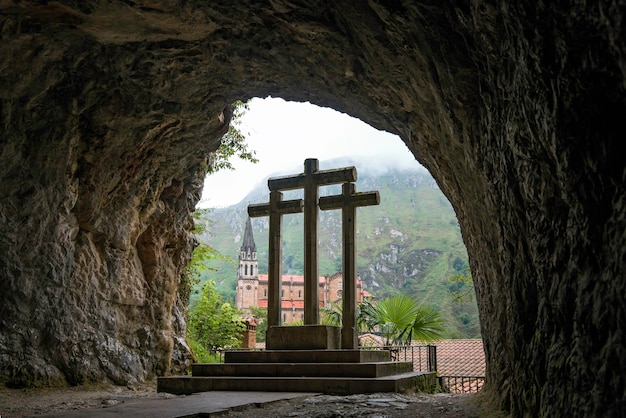 Sacred cave of Covadonga Asturias with three crosses and in the background the incredible green mountains of northern Spain