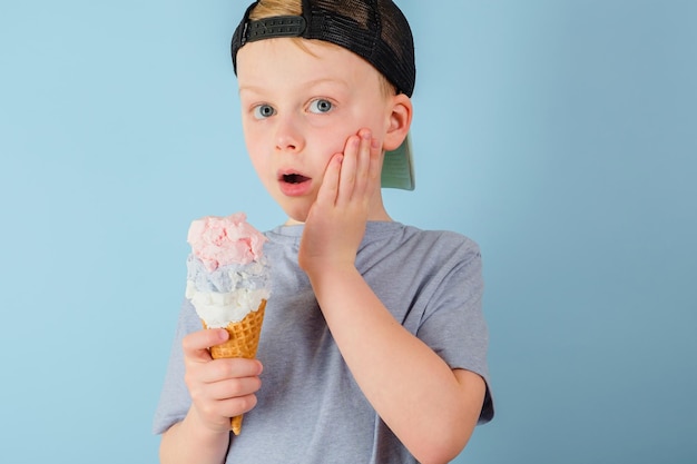 Sad boy eating ice cream and felt a sharp toothache The child grabbed his cheek dental care