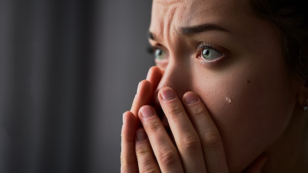 Sad desperate crying woman with folded hands and tears eyes during trouble