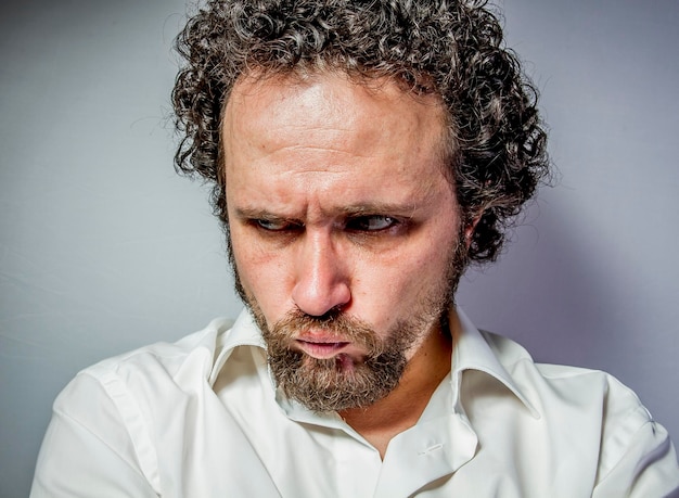 sad face, man with intense expression, white shirt