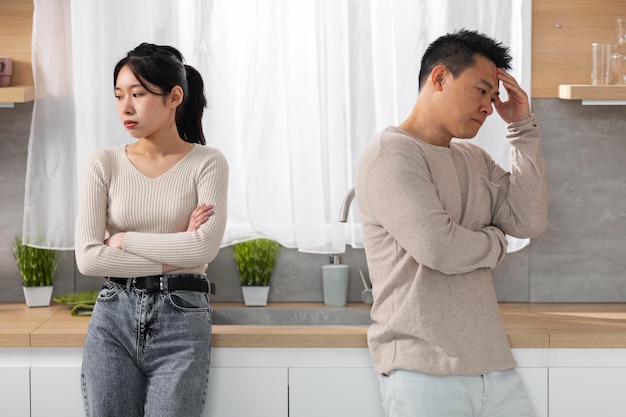 Sad japanese husband and wife experiencing difficulties in marriage