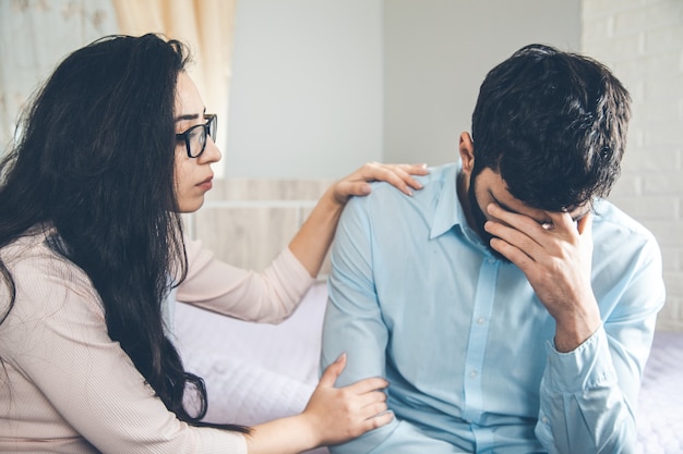 Sad man with woman in home