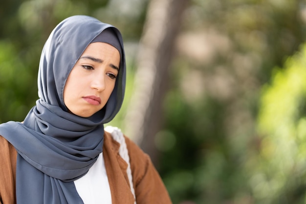 Sad muslim woman outdoors Close up picture