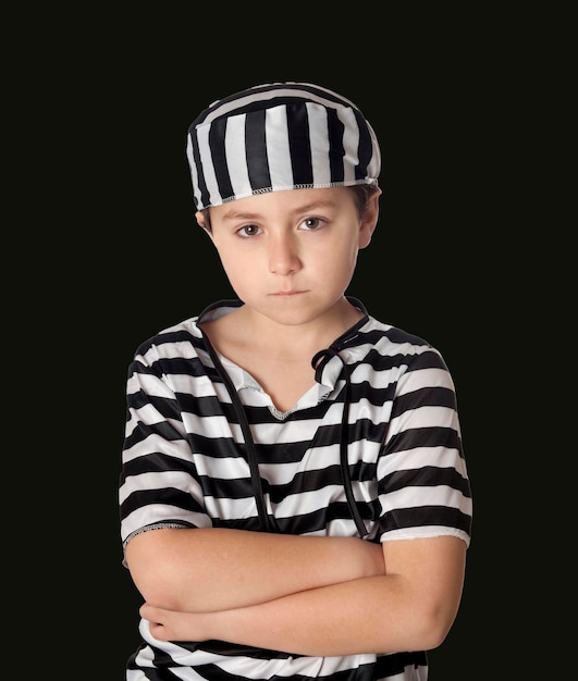 Sad prisoner wearing a striped uniform isolated on a black background