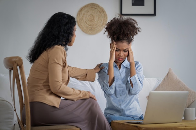 Sad PTSD woman patient in crucial therapy for mental health with psychologist depression or grief after life failure Frustrated trauma young woman talking to a psychologist about emotion in clinic