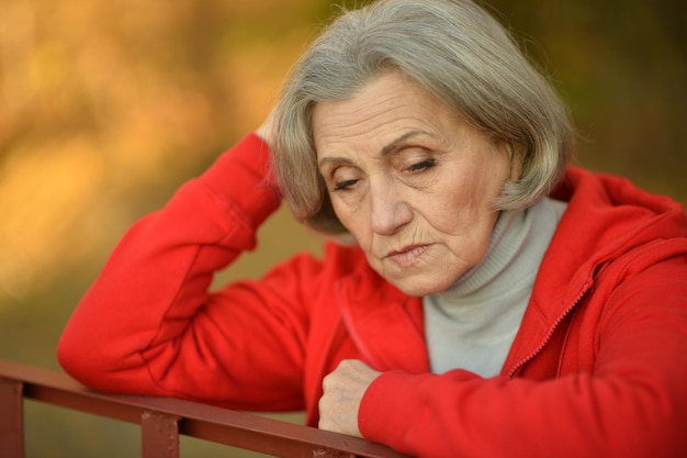 Sad senior woman in park