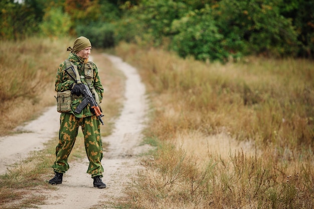 Sad solider sitting with a black rifle