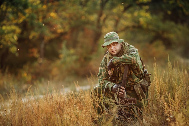 Sad solider sitting with a gun