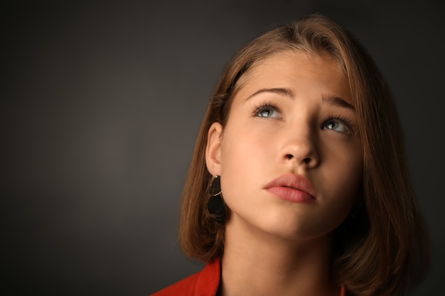 Sad teenage girl on dark