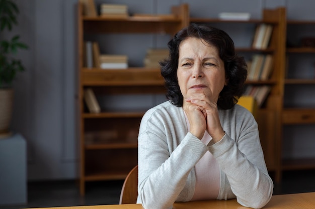 Sad tired ill sick lonely disappointed older senior woman sitting at home alone Unhappy mature grandmother experiencing grief relative death bad news Stressed elder lady suffering from loneliness