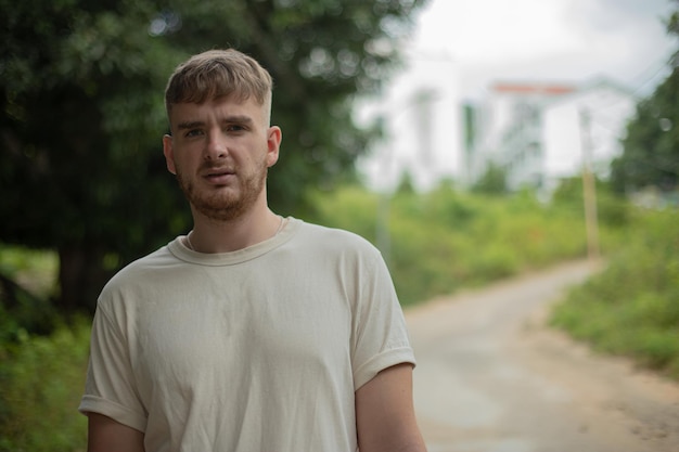 Sad upset frustrated young man outdoors on the street looking at camera