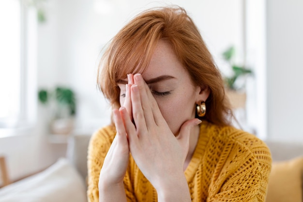 Sad woman feels miserable desperate sit on sofa look out the window thinking about personal troubles does not see way out of difficult life situation Break up heartbreak cheated girl concept