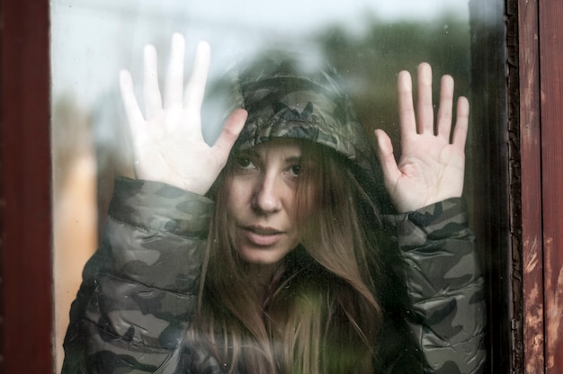 Sad woman next to the window