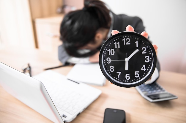 Sad working woman hand clock