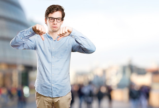 Sad young man with a loser gesture