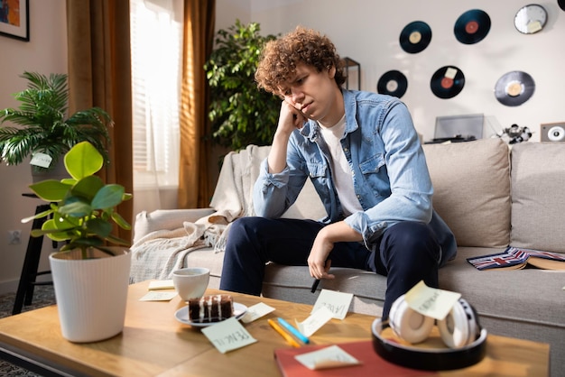 A saddened teenager looks at a stack of small cards learning a foreign language trying to learn word