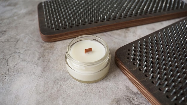 Sadhu boards for standing on metal nails with homemade candle