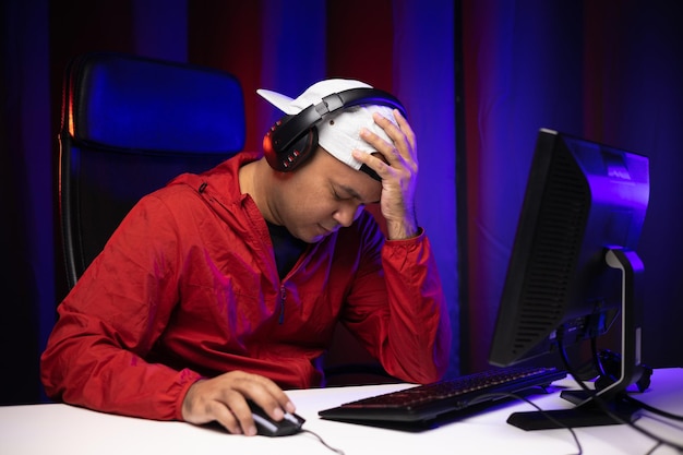 Sadness gamer man play computer pc. He lose in the game. Missed the chance to become a champion in tournament. Young indian playing video game online at home.