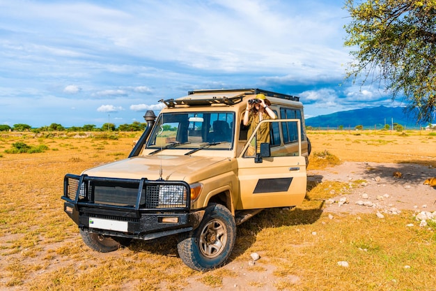 Safari animal explorer looking for a wildlife from the heep front row. Real explorer of Ngorongoro national park.