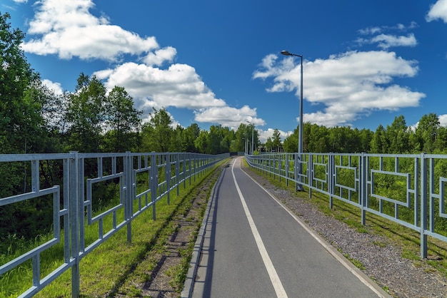 A safe bike and pedestrian path fenced on both sides with a fence