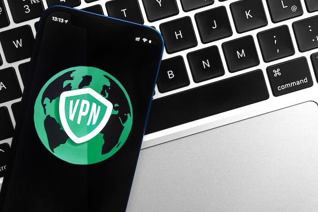 Safe internet access concept with VPN on smartphone Anonymous and secure internet on mobile phone Desktop with laptop technology background photo