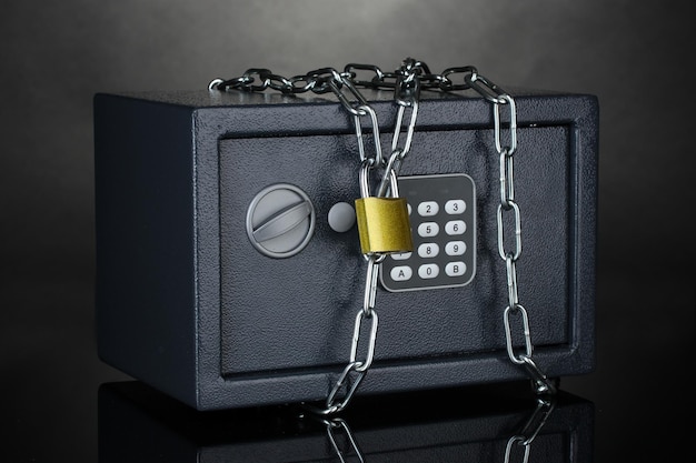 Safe with chain and lock on grey background