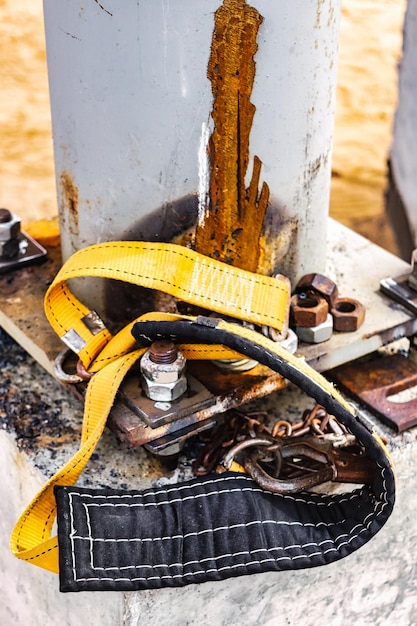 The safety belt of a welder or assembler lies on a concrete foundation at a construction site Protection of a person working at height Safety engineering