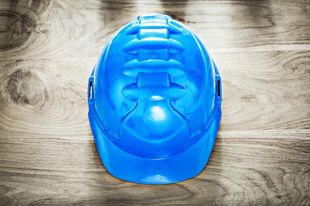 Safety building helmet on wooden board construction concept