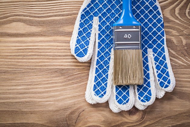 Safety gloves paintbrush on wood board construction concept