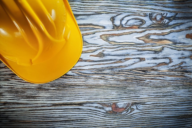 Safety hard hat on vintage wooden board