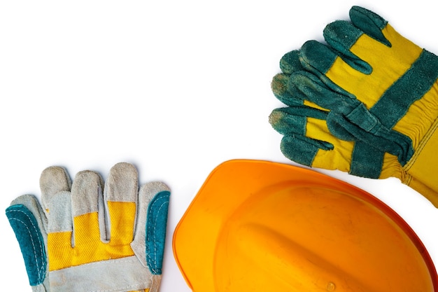 Safety hardhat and work gloves isolated on white background