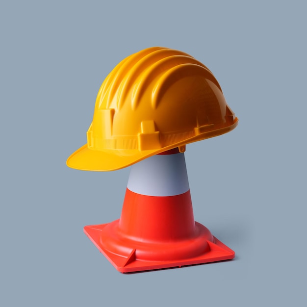 Safety helmet and traffic cone safety at work concept