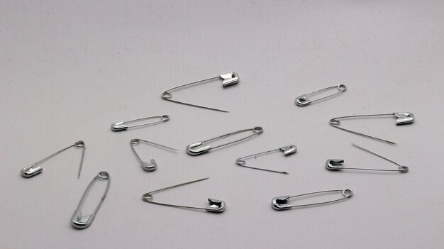 The safety pin is made of metal and silver in color