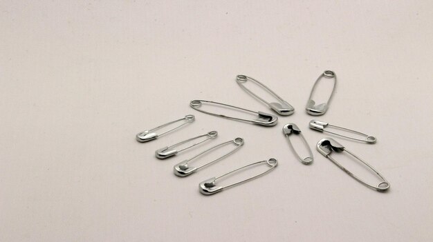 The safety pin is made of metal and silver in color