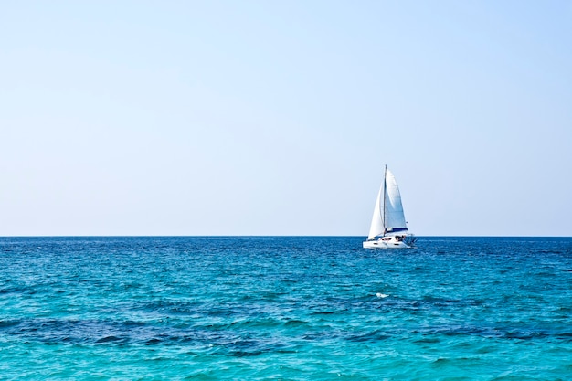 Sailboat on the horizon on a sunny day