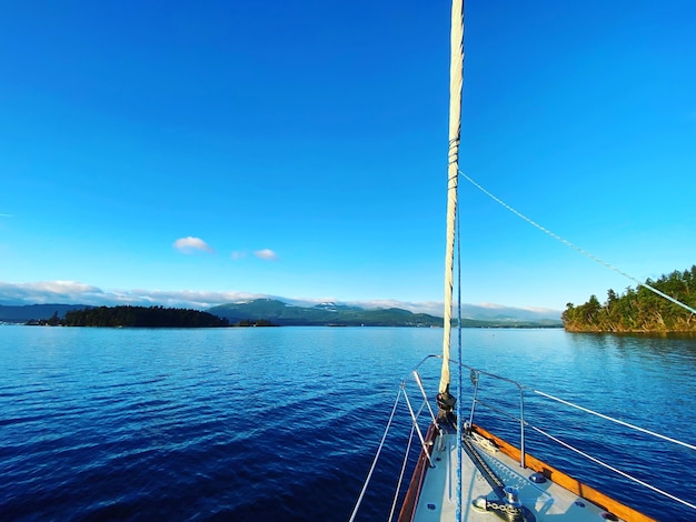 Sailboat motoring along a quiet channel