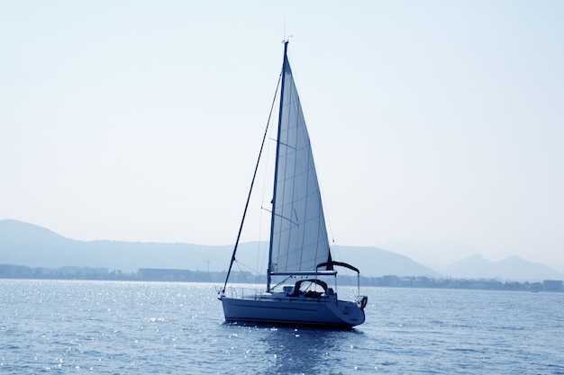 Sailboat sailing in blue mediterranean sea