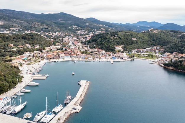 Sailboats anchored in Syvota village marina aerial drone view