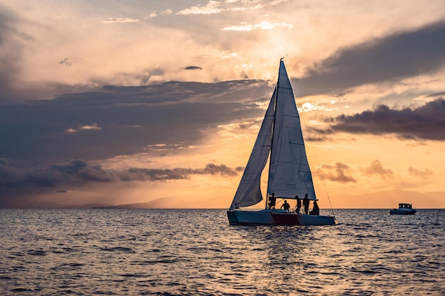 Sailboats on the background of the sunset over the sea