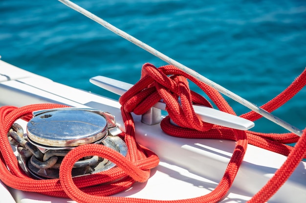 Sailing boat mooring rope tied on cleat Heavy metal chain around the winch