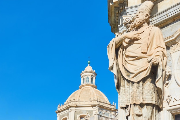 Saint James statue in the front of Saint Agatha Cathedral of Catania and the blue sky, Sicily, Italy. Copyspace composition